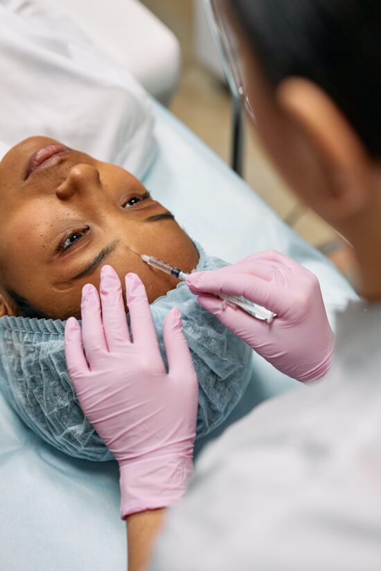 Person Ready to receive botox injection above the eyebrows
